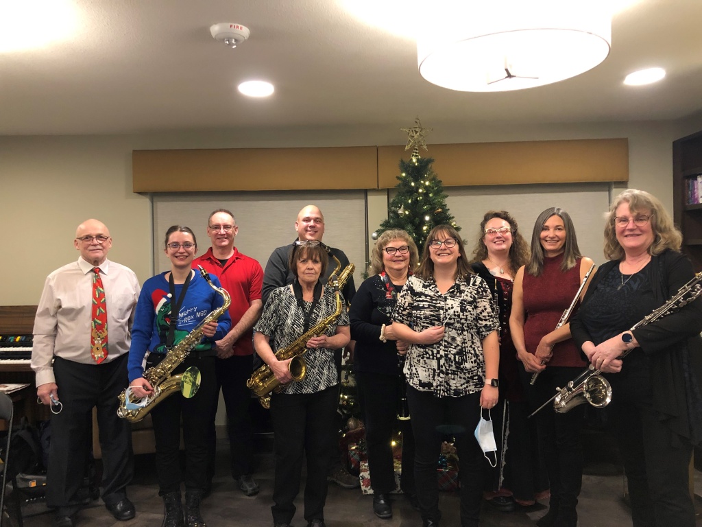 Members of the Lumsden Band in front of a Christmas tree.